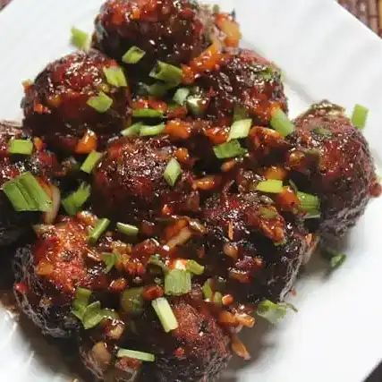 Veg manchuria — Crispy and flavorful vegetable balls tossed in a tangy, spicy soy-based at Aha Biryanis - Farmington hills, Farmington Hills