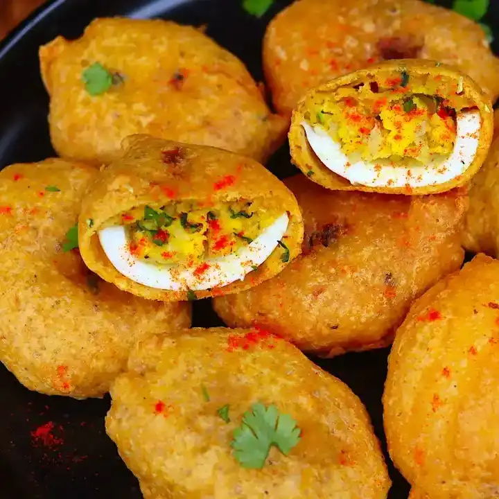 Egg Bonda — A golden, crispy shell encases a perfectly boiled egg, creating a at Aha Biryanis - Farmington hills, Farmington Hills
