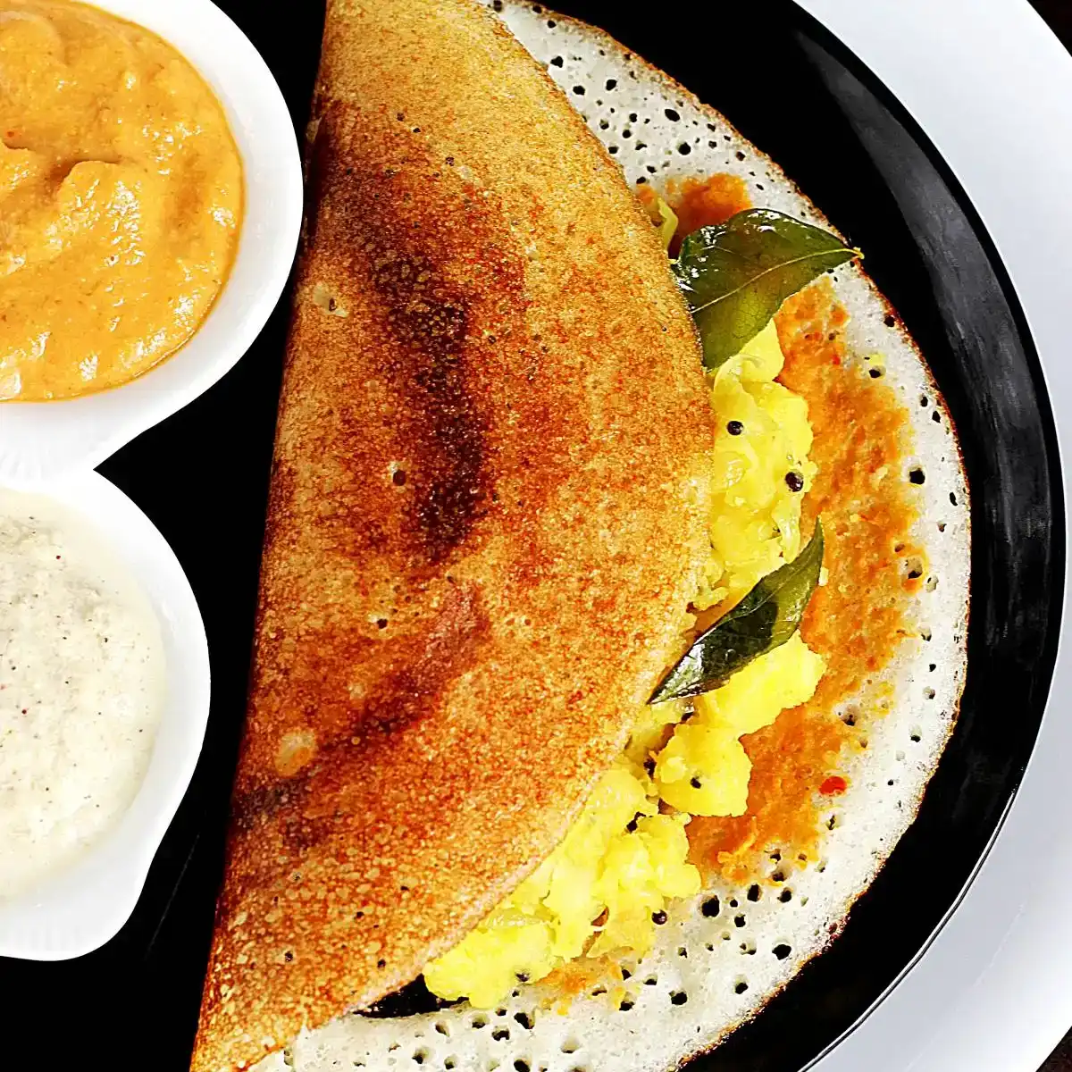 Karam Masala Dosa — Experience the symphony of textures with our Karam Masala Dosa at Aha Biryanis - Farmington hills, Farmington Hills