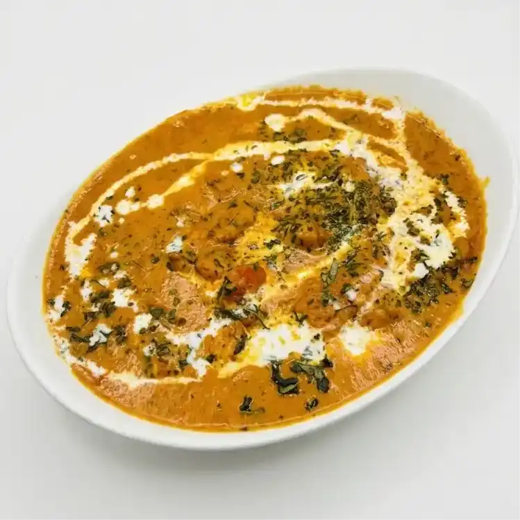 Butter Chicken — Savor succulent chicken pieces simmered in a creamy, aromatic tomato at Konaseema Cuisine, North Brunswick