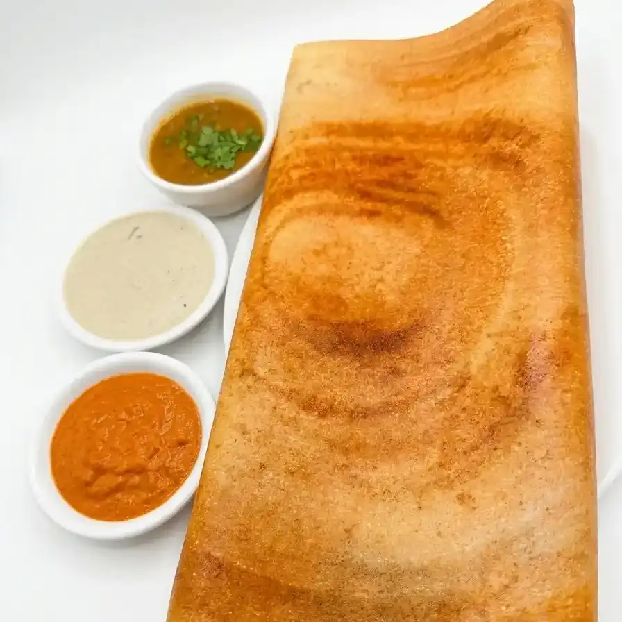Plain Dosa — A thin, crispy South Indian crepe made from fermented rice and lentil at Konaseema Cuisine, North Brunswick