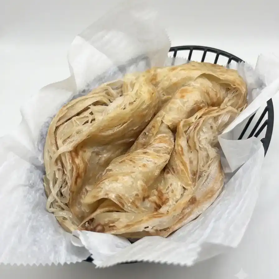 Malabar Paratha - 2Pcs — Flaky, layered Indian flatbread from Kerala, golden-browned and crisp at Konaseema Cuisine, North Brunswick