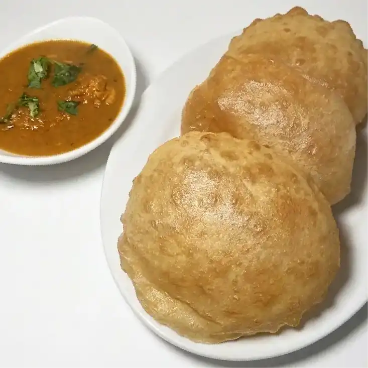Poori 3Pcs - Chicken Curry — Soft unleavened Indian bread made with wheat flour and deep fried at Konaseema Cuisine, North Brunswick