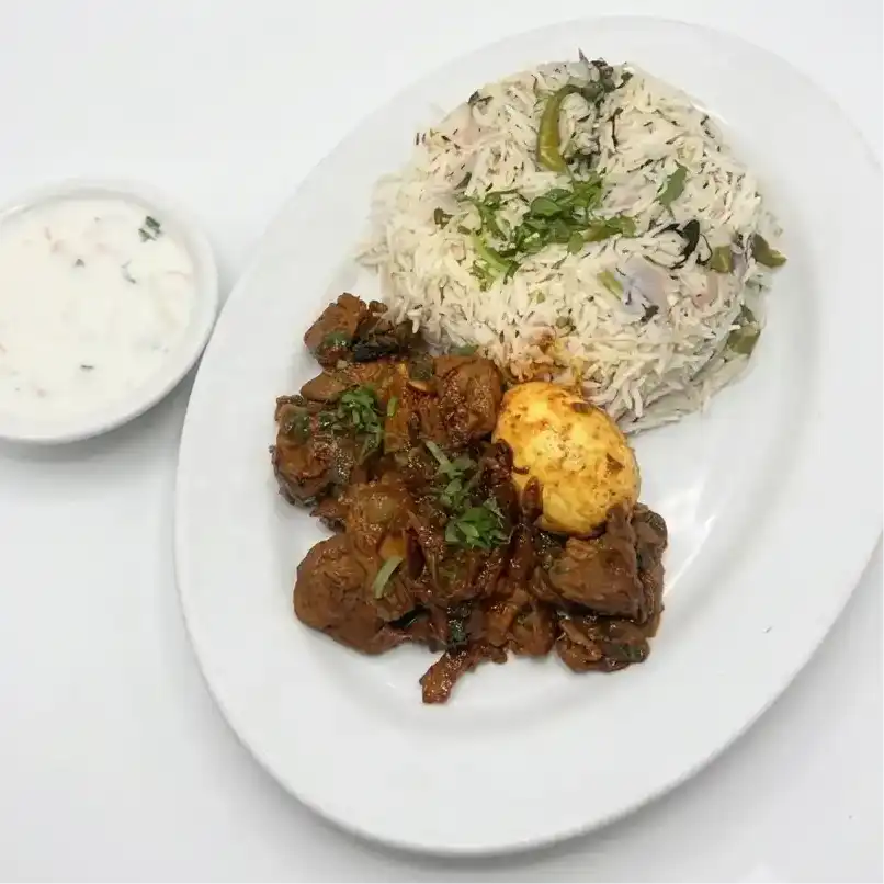 Ravulapalem Goat Fry Piece Pulao — Fragrant basmati rice topped with spicy Andhra-style tender goat fry at Konaseema Cuisine, North Brunswick
