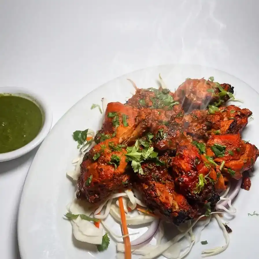 Tandoori Chicken Full — Savor a whole chicken marinated in aromatic spices and yogurt at Konaseema Rocky Hill, Rocky Hill